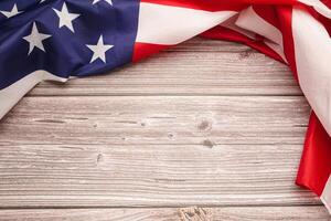 Top view of the American flag on a wooden table with copy space for text photo