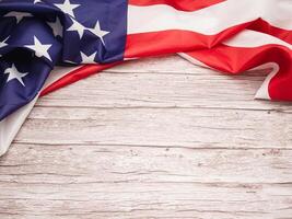 Top view of the American flag on a wooden table with copy space for text photo