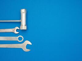 Work tools on a blue background. A screwdriver and spanner photo