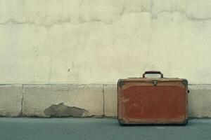 Vintage Suitcase Against Weathered Wall Evoking Nostalgia and Adventure in Urban Setting photo