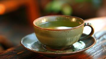 Zen-like simplicity captured in a cup of green tea on a saucer photo