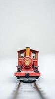 A red train with a yellow smoke stack photo