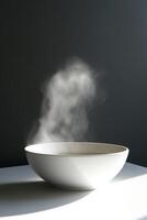 Minimalist White Bowl with Rising Steam Against Dark Background in Soft Natural Light photo