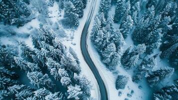 Drone shot of a road trip through a snowy mountain pass photo