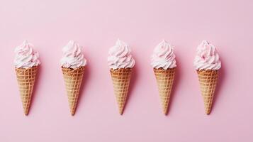 Five Pink Ice Cream Cones in a Row on Pastel Pink Background photo