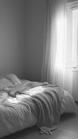 A bed with a white blanket and a gray blanket on top of it photo