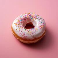 Delicious Glazed Donut with Colorful Sprinkles on a Soft Pink Background photo