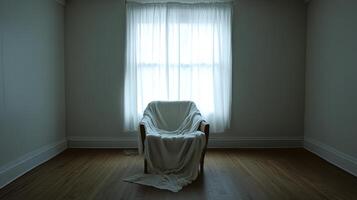A white chair is sitting in front of a window with white curtains photo