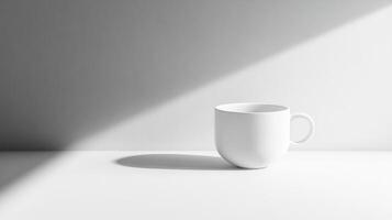 Minimalist White Ceramic Coffee Cup on a Sunlit Surface photo