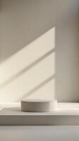 Minimalist White Pedestal with Sunlight and Shadows in Modern Interior Setting photo