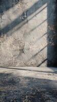 Sunlit Concrete Wall with Textured Surface and Shadows photo
