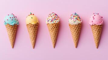 Colorful Ice Cream Cones with Sprinkles on Pink Background photo