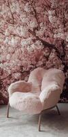 A pink chair with a floral pattern on it sits in front of a wall with a pink flo photo