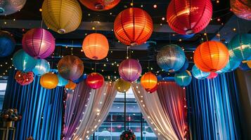 A room with many colorful lanterns hanging from the ceiling photo