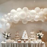 A white table with a cake and cupcakes on it photo