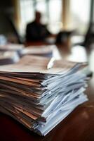 Stack of Documents on Office Desk with Pen in Sunlit Room photo