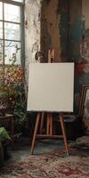 A white canvas is propped up on a wooden easel photo