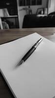 Elegant Fountain Pen on Blank Notebook Page in Monochrome Setting photo