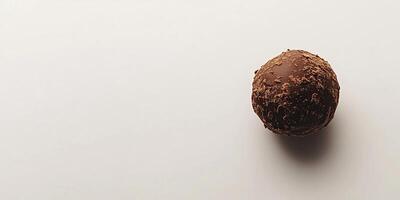 Minimalist Chocolate Truffle on White Background photo