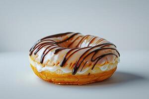 A chocolate glazed donut with a white glaze photo
