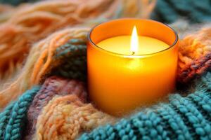 Cozy Candlelit Scene with Warm Knitted Blanket and Glowing Candle photo