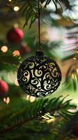 A Christmas tree with a black ornament hanging from it photo
