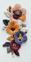 Intricate Embroidered Floral Design with Colorful Blossoms and Leaves on White Background photo