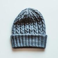 A gray knit hat with a blue stripe sits on a white background photo