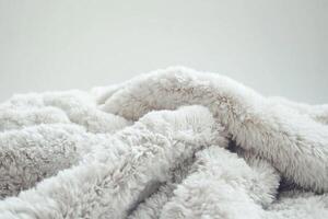 A fluffy white blanket with a fuzzy texture photo