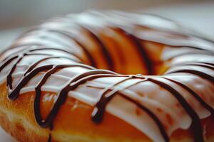Close-Up of a Delicious Glazed Donut with Chocolate Drizzle on a Soft Focus Background photo