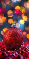 A red ornament with a silver chain is on a table photo
