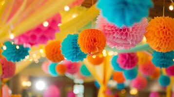 A colorful display of paper pom poms hangs from the ceiling photo