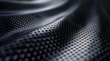 A close up of a black metal surface with a lot of holes photo
