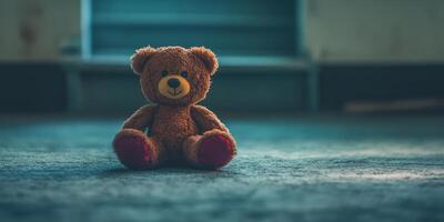 A teddy bear is sitting on the floor photo