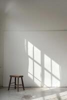 Minimalist Interior with Wooden Stool and Sunlit Wall Casting Geometric Shadows photo