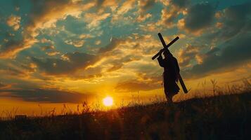 Silhouette of a person carrying a cross photo