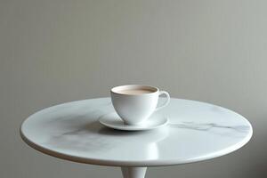 A white coffee cup sits on a white table photo