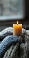 A candle is lit on a blanket photo