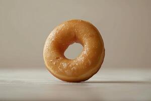 Delicious Glazed Donut on Minimalist Background Perfect for Bakery and Dessert Themes photo