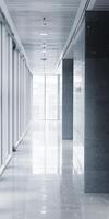 Modern Office Corridor with Glass Walls and Sleek Design Featuring Natural Light photo
