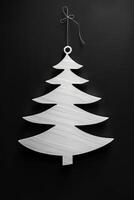 A white Christmas tree ornament hanging from a string photo