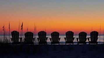 Serene silhouette of beach chairs lined up along the shoreline photo