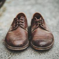 Vintage Brown Leather Shoes on Concrete Surface with Soft Focus Background photo