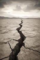 Aerial View of Dramatic Cracked Earth Landscape Under Moody Sky photo