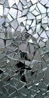 A glass window with a lot of broken pieces photo
