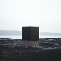 A black box is sitting on a rocky shore photo