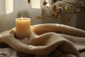 A candle is lit on a blanket photo