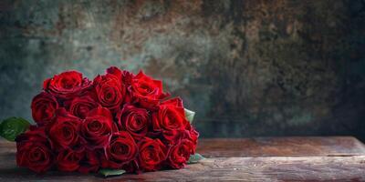 Heart-shaped bouquet of red roses on a rustic wooden table for Valentine's Day. photo