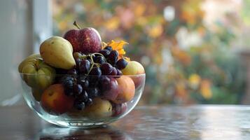 Clean and modern arrangement of assorted autumn fruits in a glass bowl photo