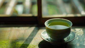 Zen-like simplicity captured in a cup of green tea on a saucer photo